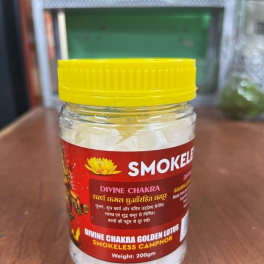 Jar of smokeless camphor with a yellow lid on a wooden surface