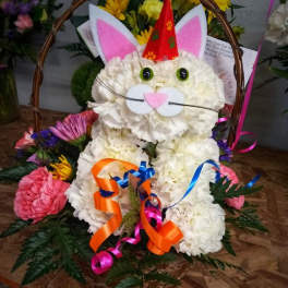 White floral cat basket with pink ears and ribbon accents