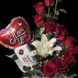 Red roses and white lilies in a gift box with a heart balloon