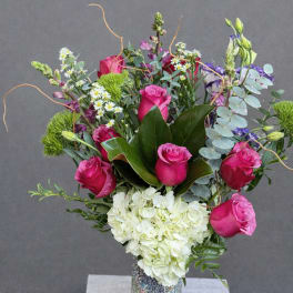 Pink roses and white hydrangea in a mosaic vase