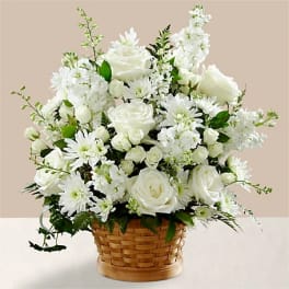 White roses and daisies arranged in a woven basket