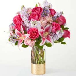Bouquet of pink roses and lilies in a glass vase