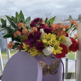 Multi color beautiful flower arrangement in a luxurious lavender box by lav.ishbouquets