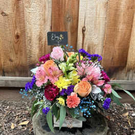 Colorful mixed bouquet in a white box with roses and alstroemeria