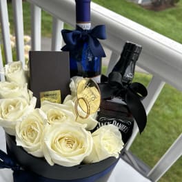 White roses accompanied with a jack daniel and white wine in a black luxurious box by lav.ishbouquets