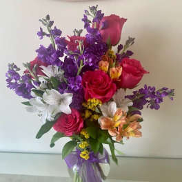 Celebrate Your Day with mix flowers arranged in a vase.