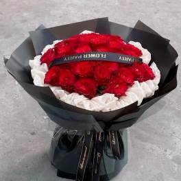 Bouquet of red and white roses wrapped in black paper