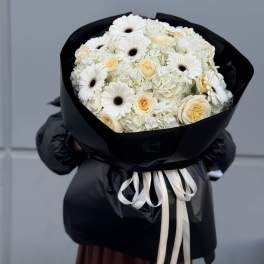 Bouquet in black stylish packaging, with white flowers