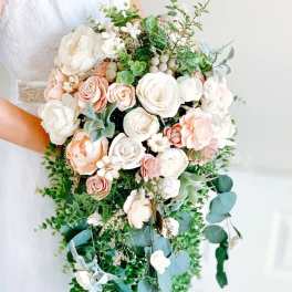 Cascading bridal bouquet of white and blush roses and peonies with trailing greenery