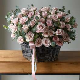 basket of pink roses with eucalyptus