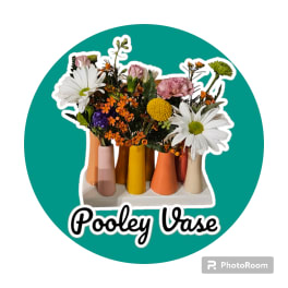 Mixed flowers arranged in colorful small vases on a teal circle background