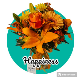 Orange and yellow bouquet with lilies and daisies in a vase