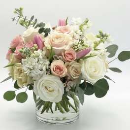 Pink and white rose bouquet in a clear glass vase