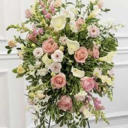 Pastel floral standing spray with pink roses and white calla lilies