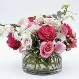 Pink and white rose bouquet in a clear glass vase