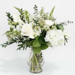 White floral bouquet in a clear glass vase