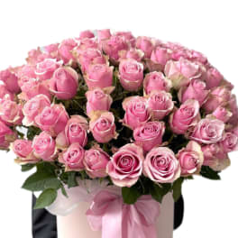 Arrangement of light pink roses in a hat box
