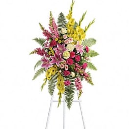 Tall floral spray on a stand with pink, yellow, and white flowers