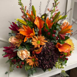 Mixed bouquet with orange lilies, hydrangea, roses, and calla lilies