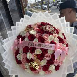 Large bouquet of red, pink, and white roses with a birthday ribbon