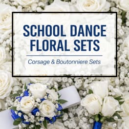 White rose corsage and boutonniere sets with blue ribbon accents