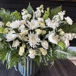Large white floral arrangement in a gray vase