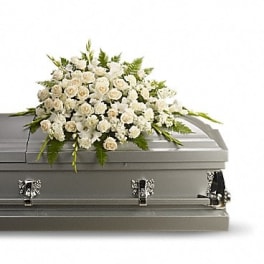 White floral spray on a gray casket