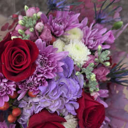 Bouquet of red roses and purple chrysanthemums with pink accents