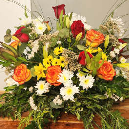 Mixed bouquet of red and orange roses with white daisies and lilies