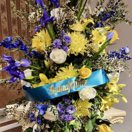 Large standing floral spray with a blue "Grandfather" ribbon