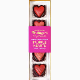 Rectangular box of five red heart-shaped chocolate truffles with pink branded sleeve