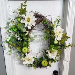 Floral wreath with white daisies and green apples on a grapevine base