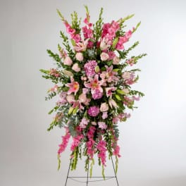 Tall pink floral standing spray on an easel