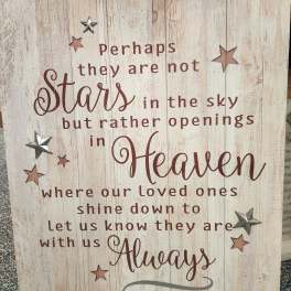 Wooden sign with a memorial quote and star accents