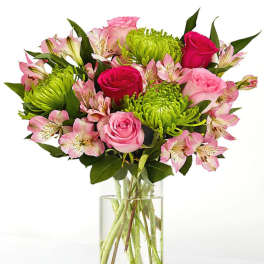 Pink roses and green chrysanthemums in a clear glass vase