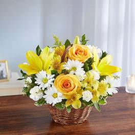 Yellow and white flower arrangement in a wicker basket