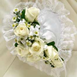 White rose bridal bouquet with small daisy-like flowers and lace trim