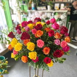 Large bouquet of multicolored roses on a tall stand