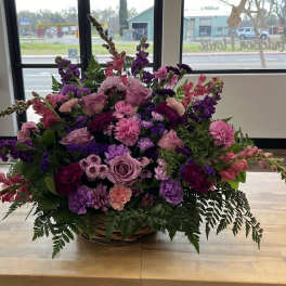 Large basket arrangement of pink and purple flowers