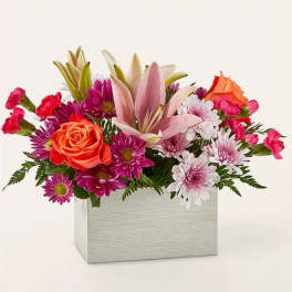 Mixed bouquet of lilies, roses, and daisies in a white box