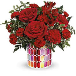Red roses and carnations in a colorful mosaic vase