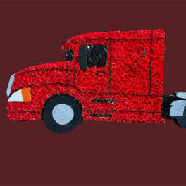 Red toy semi-truck on a solid maroon background
