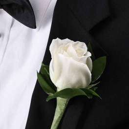 White rose boutonniere on a black suit jacket