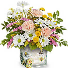 Mixed bouquet of daisies, carnations, and yellow filler flowers in a painted glass vase