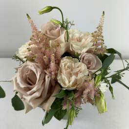 Bouquet of blush and cream roses with pink filler flowers