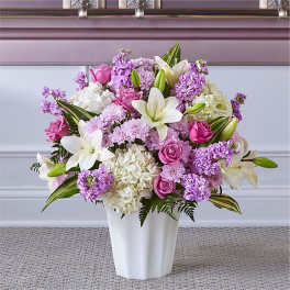 Pink and white flower arrangement in a white vase