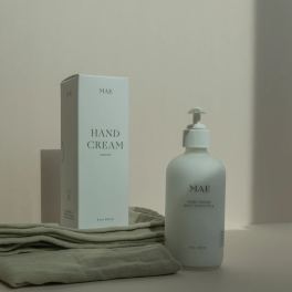 Hand cream bottle and box on folded cloth