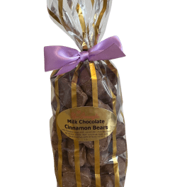 Bag of milk chocolate cinnamon bears tied with a purple ribbon