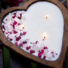 Heart-shaped candle with pink and red petals