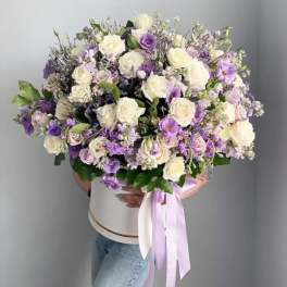 Large bouquet of white and lavender roses with a ribboned box